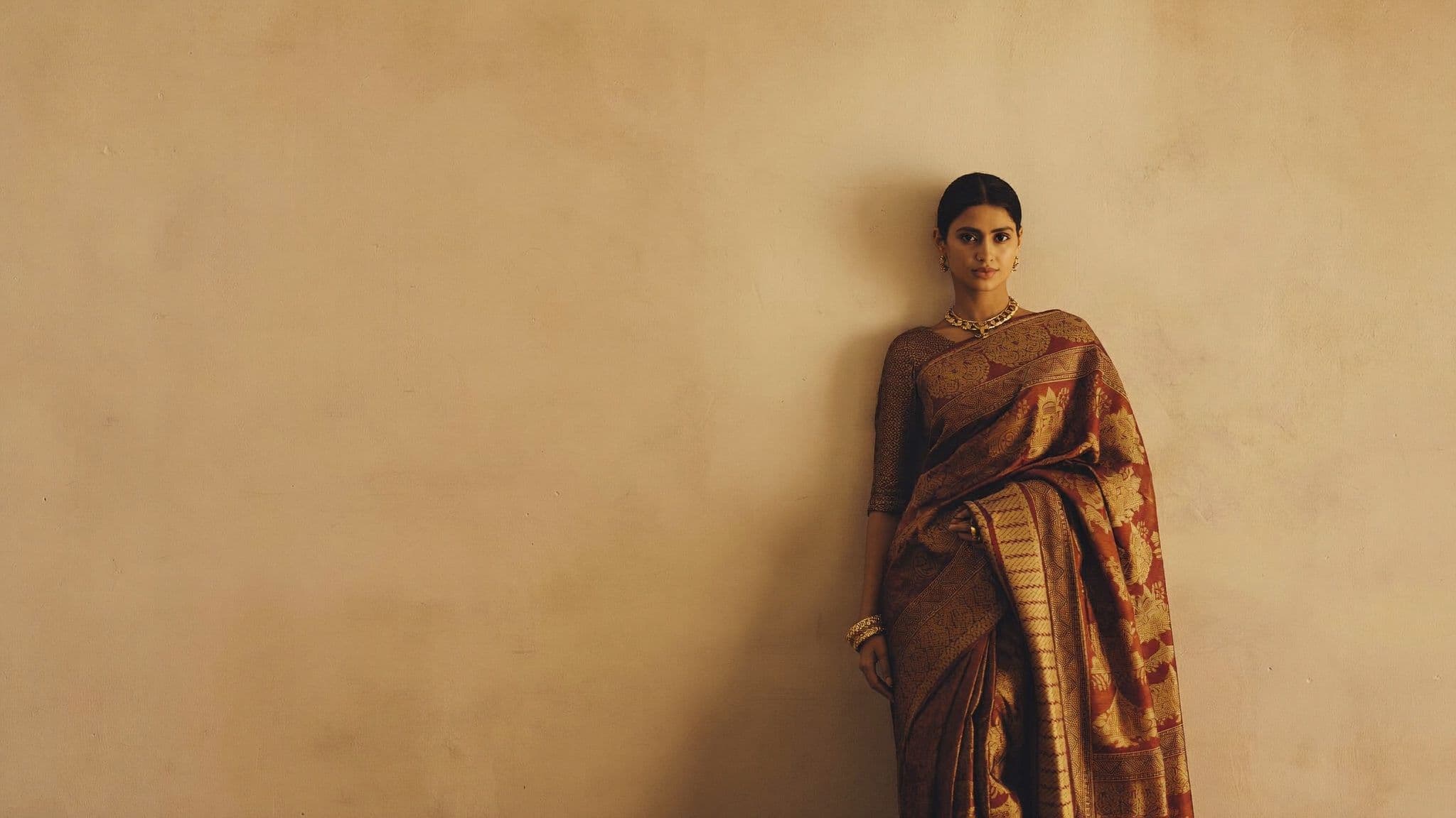A woman in an ornate handwoven Kanjivaram silk saree